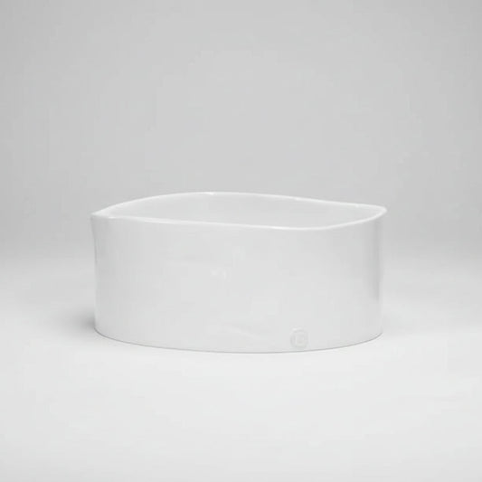 Large handmade ceramic bowl by Montes Doggett, creamy white glaze, oval shape.