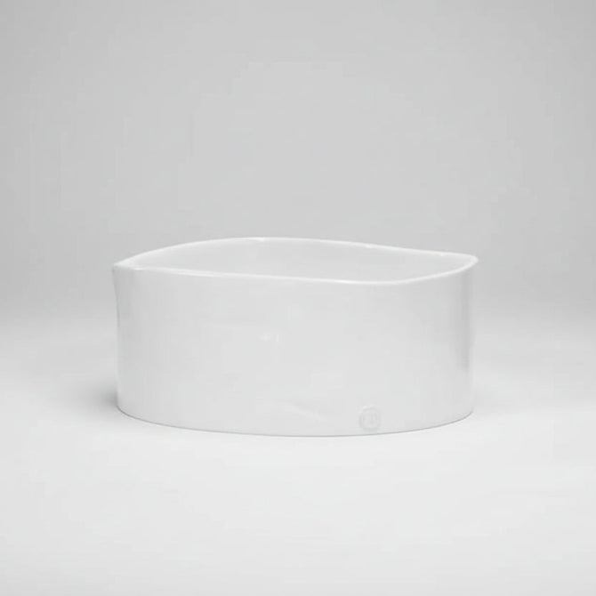 Large handmade ceramic bowl by Montes Doggett, creamy white glaze, oval shape.
