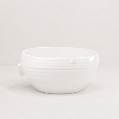 Handmade Montes Doggett ceramic bowl, creamy white glaze, 11.5"D x 5.5"H, subtle horizontal ridges.