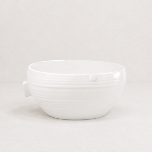 Handmade Montes Doggett ceramic bowl, creamy white glaze, 11.5"D x 5.5"H, subtle horizontal ridges.