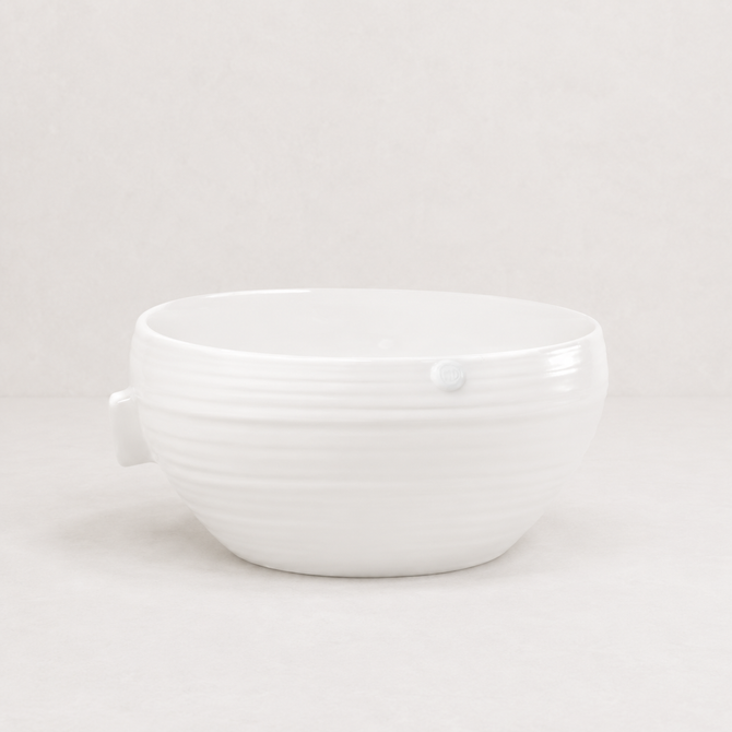 Handmade Montes Doggett ceramic bowl, creamy white glaze, 11.5"D x 5.5"H, subtle horizontal ridges.