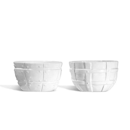 Set of 2 white ceramic bowls by Montes Doggett, one with textured dots, the other with a basket weave design.