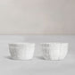 Set of 2 white ceramic bowls by Montes Doggett, 5"D x 3.25"H, with decorative basket weave texture.
