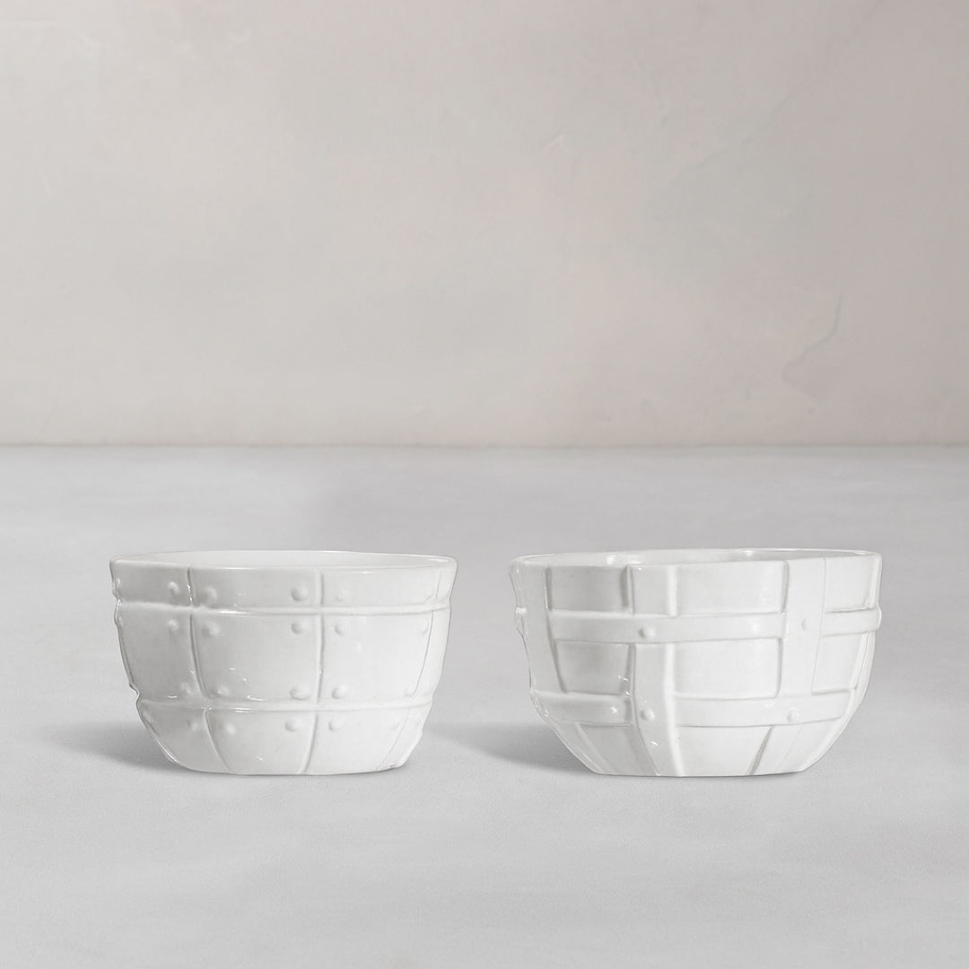 Set of 2 white ceramic bowls by Montes Doggett, 5"D x 3.25"H, with decorative basket weave texture.