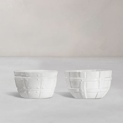 Set of 2 white ceramic bowls by Montes Doggett, 5"D x 3.25"H, with decorative basket weave texture.