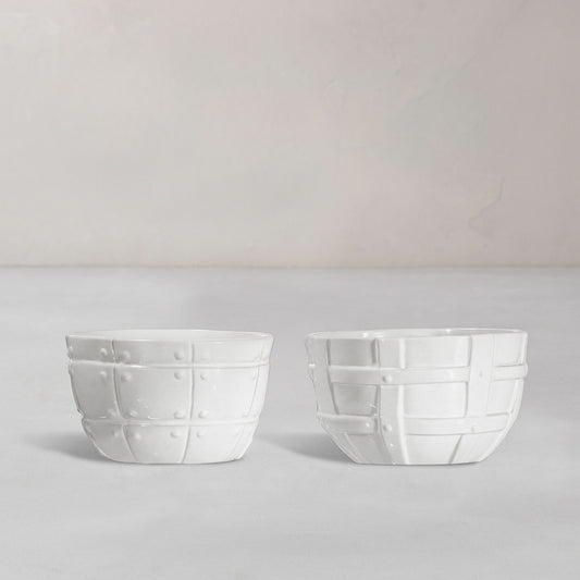 Set of 2 white ceramic bowls by Montes Doggett, 5"D x 3.25"H, with decorative basket weave texture.