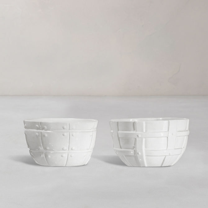 Set of 2 white ceramic bowls by Montes Doggett, 5"D x 3.25"H, with decorative basket weave texture.