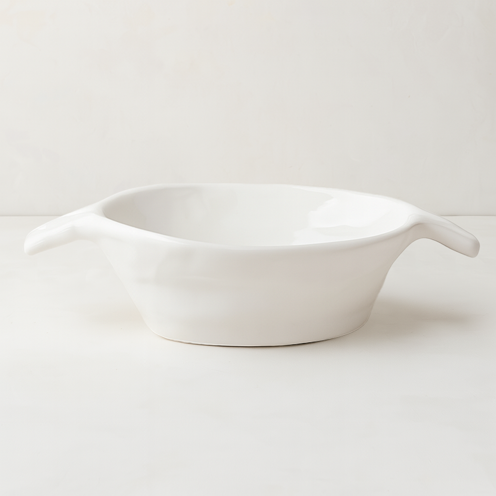 Handmade Montes Doggett ceramic bowl, creamy white glaze, 8.5"Dia x 2.75"H, with small handles.