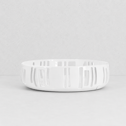 Handmade creamy white ceramic colander by Montes Doggett, 12"Dia x 3.5"H, with vertical slotted design.