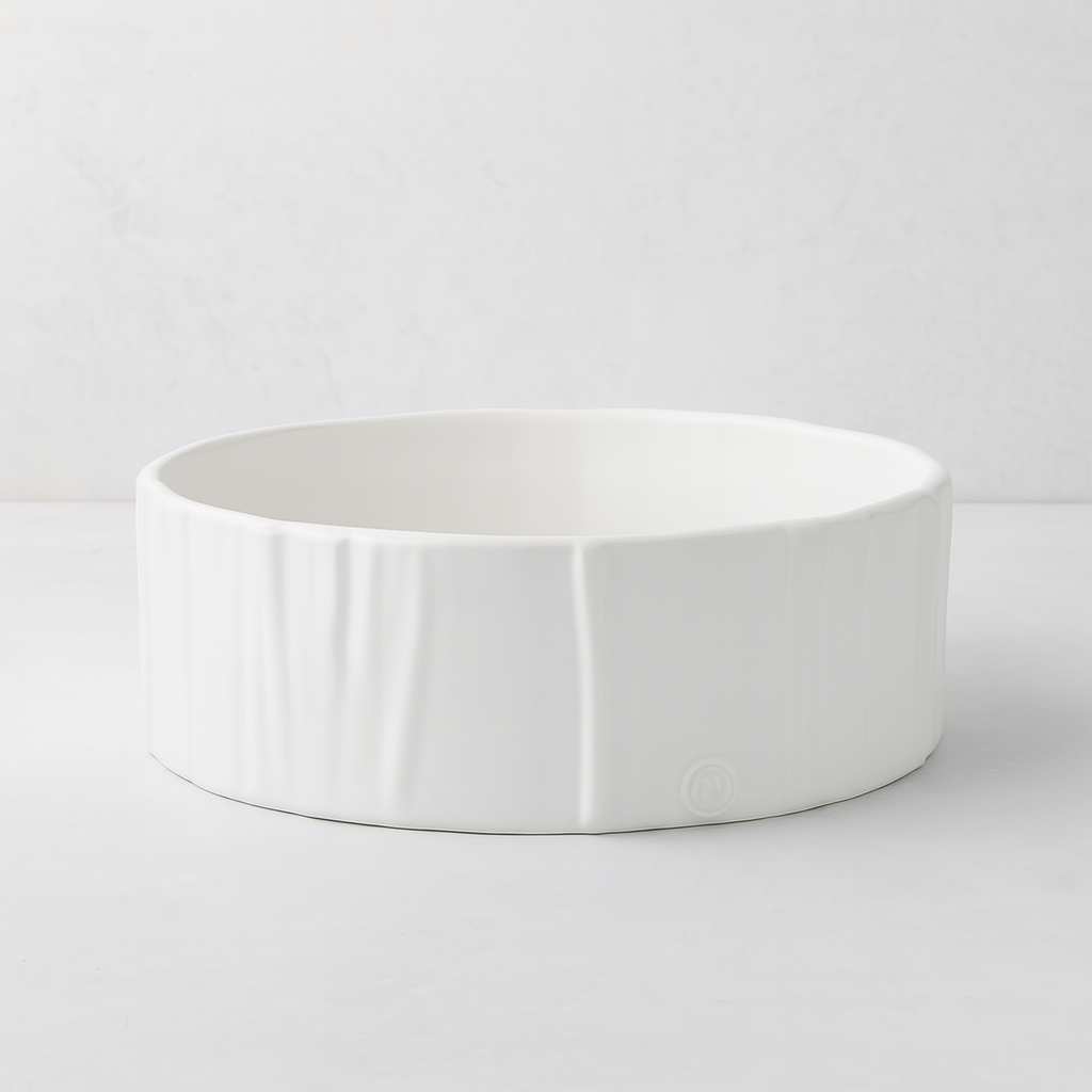 Handmade creamy white ceramic dog bowl by Montes Doggett, 8"Dia x 3"H, with textured sides.