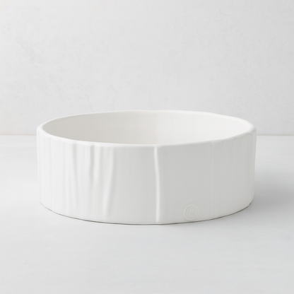 Handmade creamy white ceramic dog bowl by Montes Doggett, 8"Dia x 3"H, with textured sides.