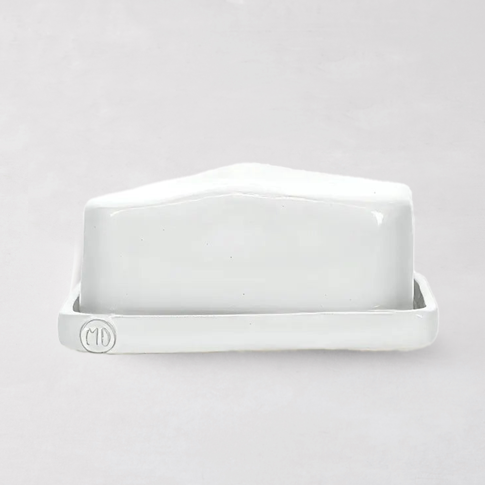 Handmade creamy white ceramic European butter dish by Montes Doggett, with "MD" logo.