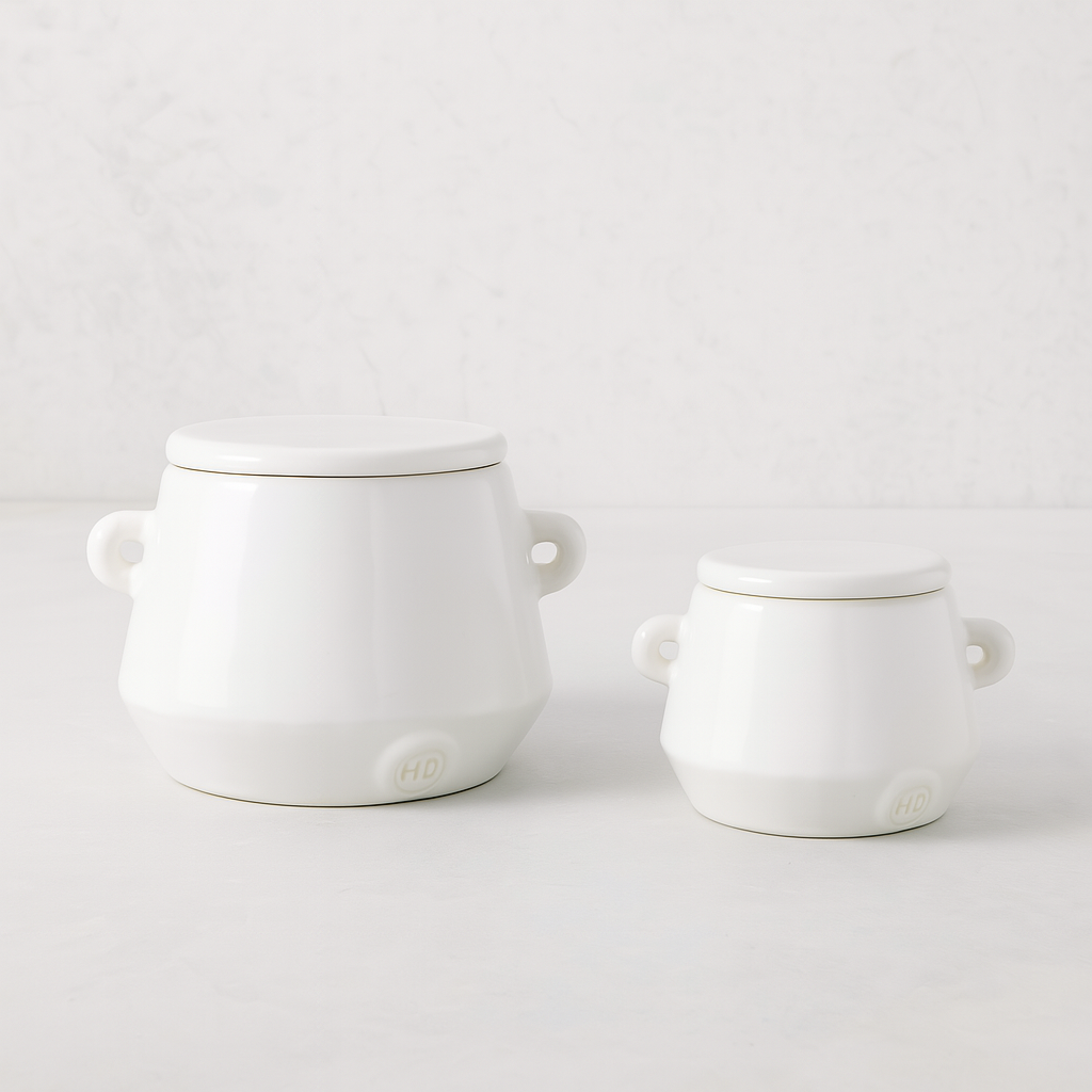 Set of 2 handmade creamy white ceramic mini canisters with lids and small handles by Montes Doggett.
