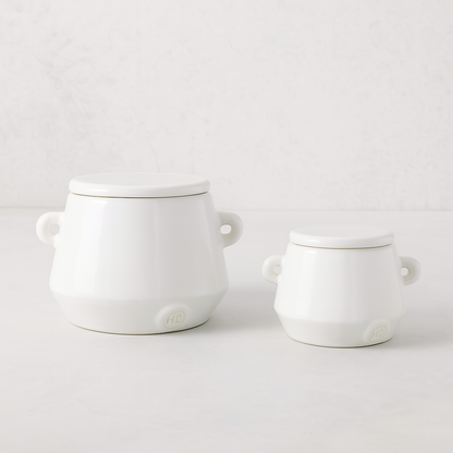 Set of 2 handmade creamy white ceramic mini canisters with lids and small handles by Montes Doggett.
