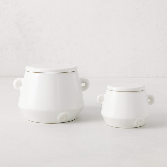 Set of 2 handmade creamy white ceramic mini canisters with lids and small handles by Montes Doggett.