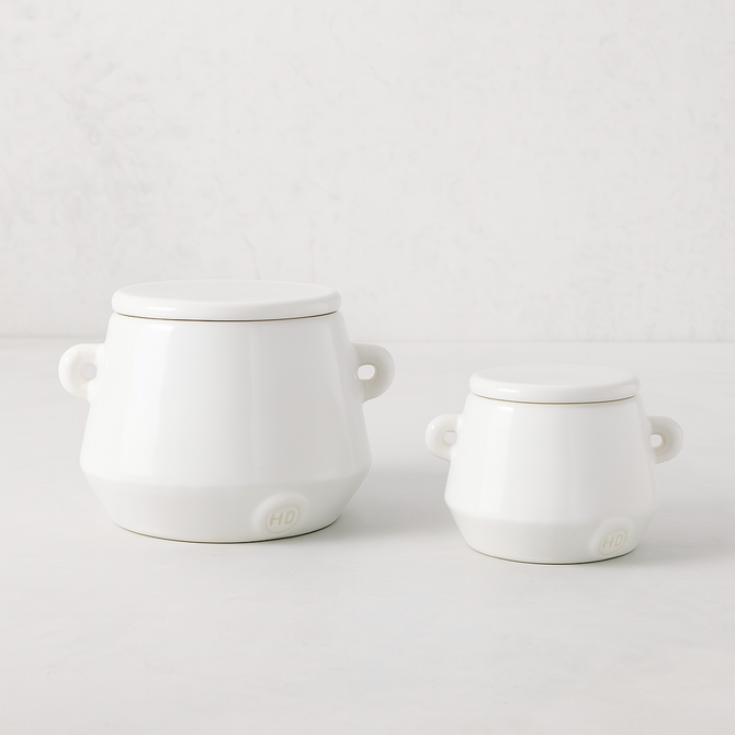 Set of 2 handmade creamy white ceramic mini canisters with lids and small handles by Montes Doggett.