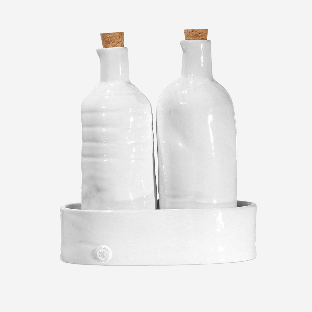 Handmade Montes Doggett ceramic oil & vinegar cruets in creamy white with cork stoppers, on a matching tray.