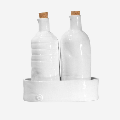 Handmade Montes Doggett ceramic oil & vinegar cruets in creamy white with cork stoppers, on a matching tray.