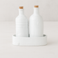 Handmade creamy white ceramic oil and vinegar cruets with corks in a matching tray by Montes Doggett.