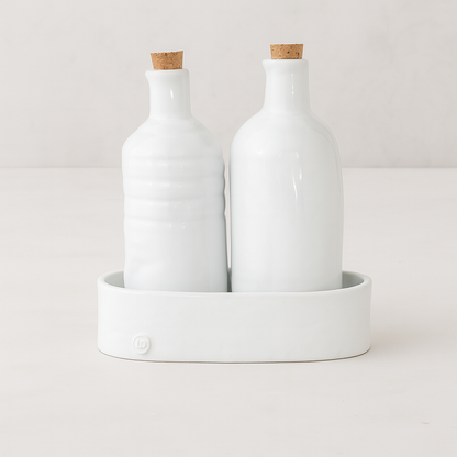 Handmade creamy white ceramic oil and vinegar cruets with corks in a matching tray by Montes Doggett.