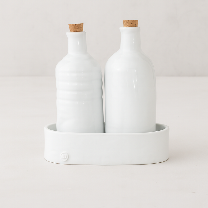 Handmade creamy white ceramic oil and vinegar cruets with corks in a matching tray by Montes Doggett.