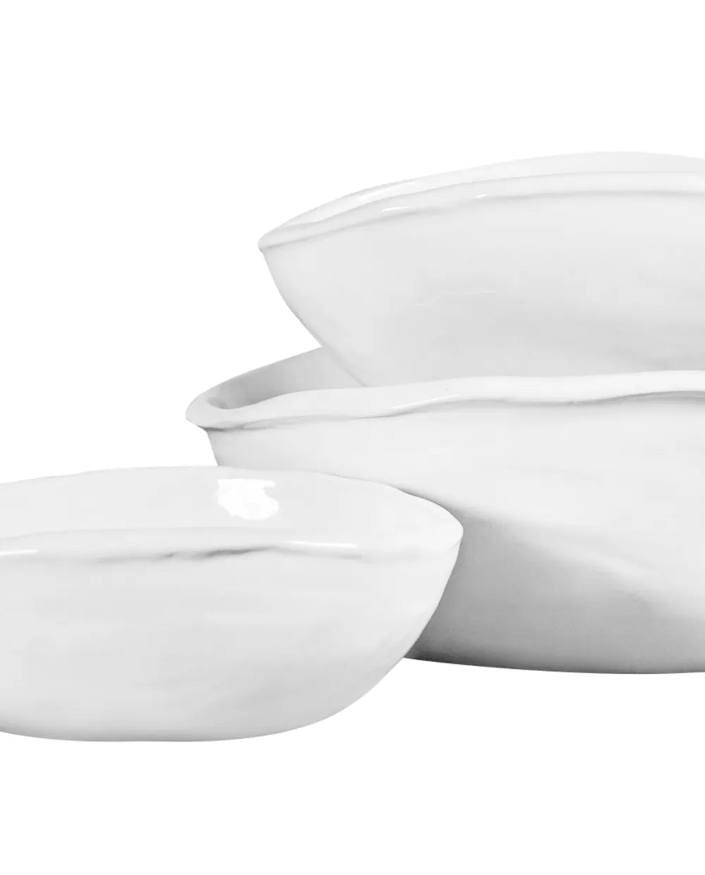 Set of 3 handmade Montes Doggett ceramic oval bowls in creamy white glaze, stacked.