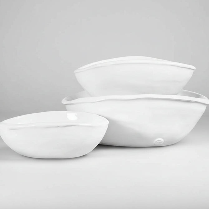 Set of 3 handmade Montes Doggett oval ceramic bowls in creamy white glaze, varying sizes.