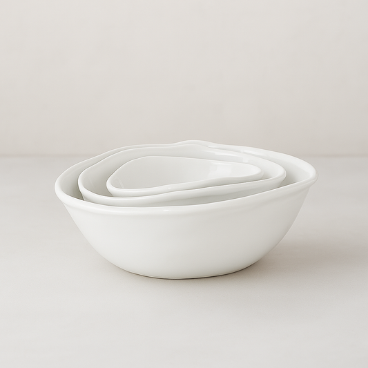 Set of 3 Montes Doggett handmade white ceramic oval bowls, nested.