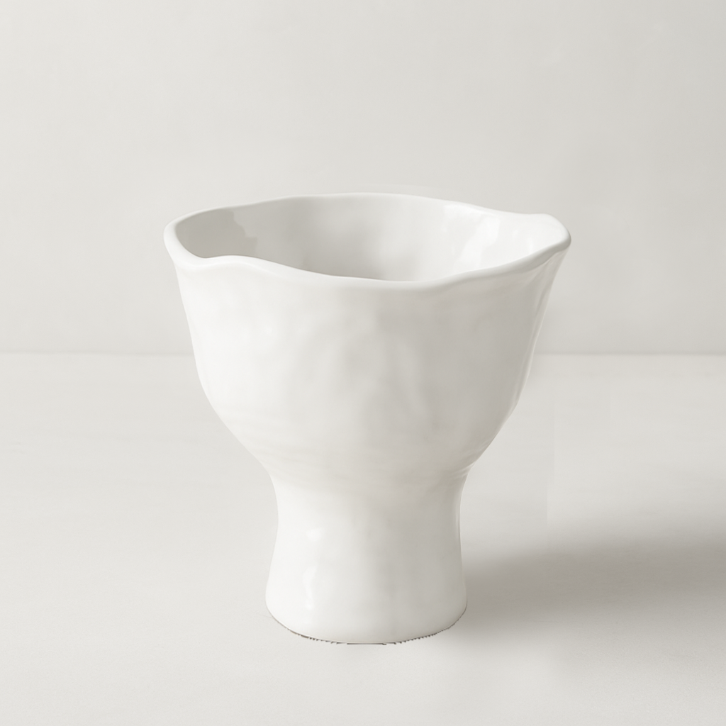 White ceramic pedestal bowl by Montes Doggett, handmade with organic shapes and textured glaze.