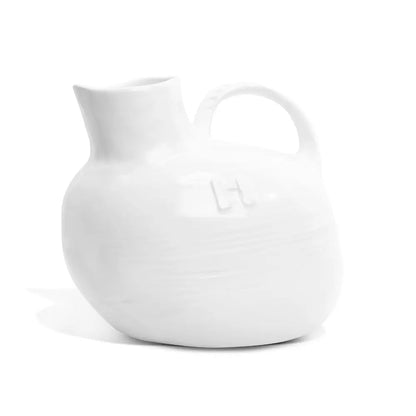 Handmade Montes Doggett ceramic pitcher, creamy white glaze, 8"L x 6"W x 7"H, with handle.