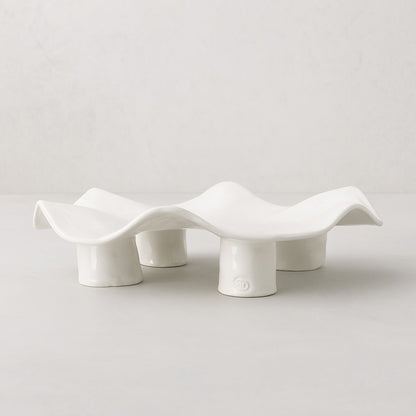 Handmade creamy white ceramic platter 5450 by Montes Doggett, organic wavy shape on four legs.