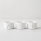 Set of 3 handmade creamy white ceramic ramequins, 3"Dia x 2"H, with organic shape and subtle vertical detail.