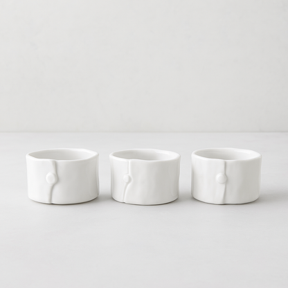 Set of 3 handmade creamy white ceramic ramequins, 3"Dia x 2"H, with organic shape and subtle vertical detail.