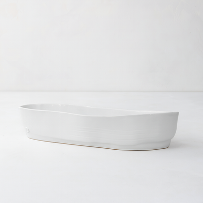 Handmade creamy white ceramic oval serve bowl by Montes Doggett, 15.5"L.
