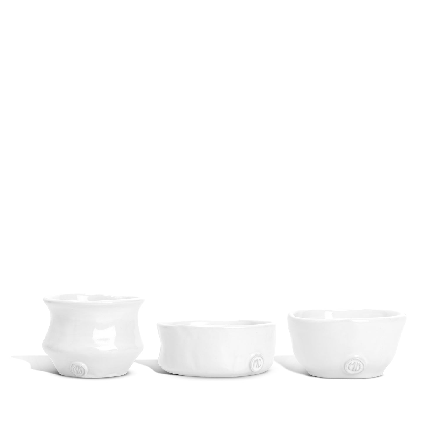 Set of 3 handmade Montes Doggett creamy white ceramic serve bowls with organic shapes.