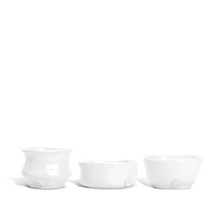 Set of 3 handmade Montes Doggett creamy white ceramic serve bowls with organic shapes.