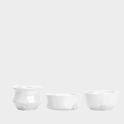 Set of 3 handmade Montes Doggett creamy white ceramic serve bowls with organic shapes.