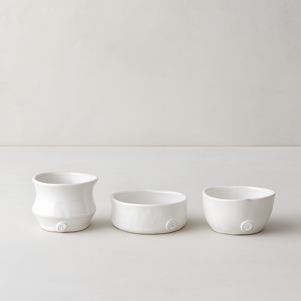 Set of 3 handmade Montes Doggett creamy white ceramic serve bowls, various organic shapes.