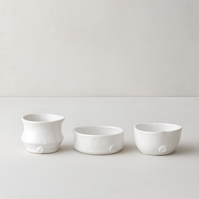 Set of 3 handmade Montes Doggett creamy white ceramic serve bowls, various organic shapes.