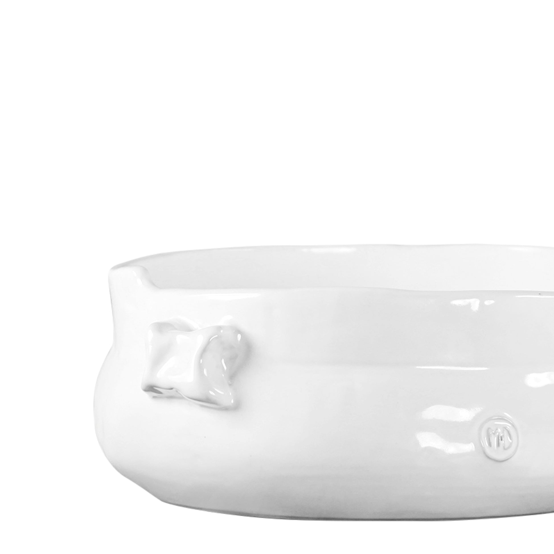 Handmade creamy white ceramic serve bowl with organic shape and small decorative handles.
