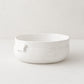 Handmade creamy white ceramic serve bowl by Monica Porter, 8.5"Dia x 3.5"H, with organic shape and small handle.