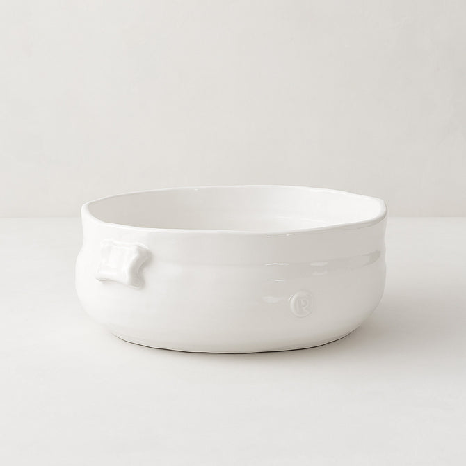 Handmade creamy white ceramic serve bowl by Monica Porter, 8.5"Dia x 3.5"H, with organic shape and small handle.