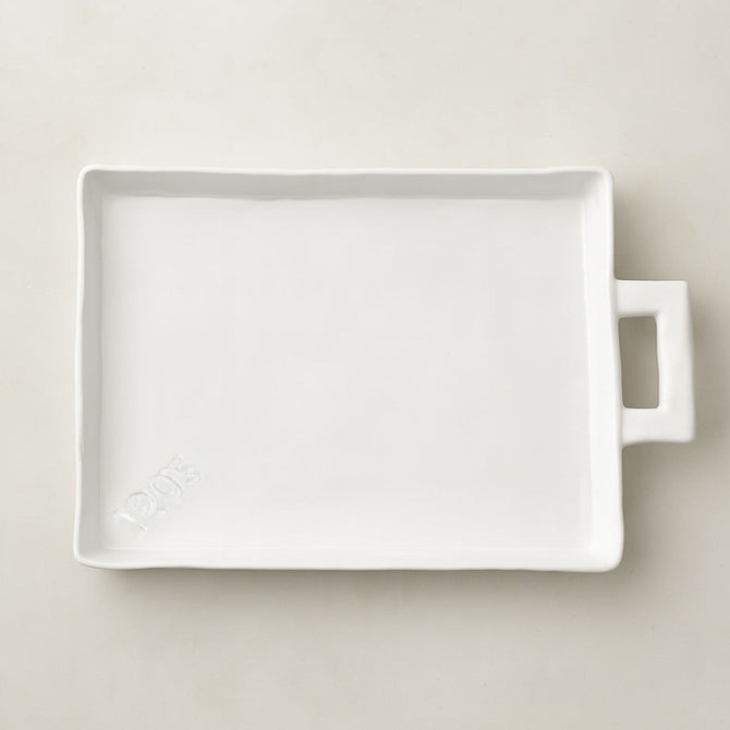 Handmade Montes Doggett Ceramic Platter 5454, creamy white, oversized, organic shape, with handle and "1205" stamp.