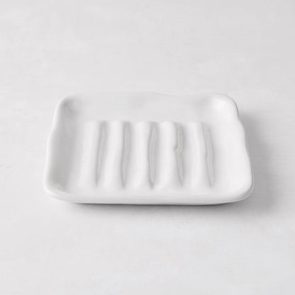 White handmade ceramic soap dish 5270 by Montes Doggett, 5" square, with organic shape and multiple ridges.