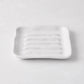 White handmade ceramic soap dish 5270 by Montes Doggett, 5" square with organic shape and multiple ridges.