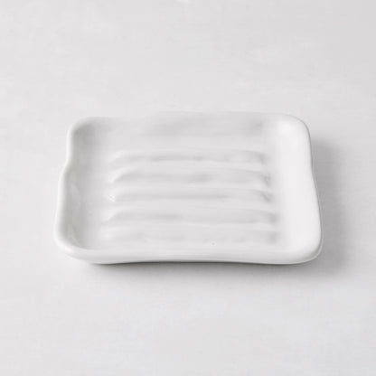 White handmade ceramic soap dish 5270 by Montes Doggett, 5" square with organic shape and multiple ridges.