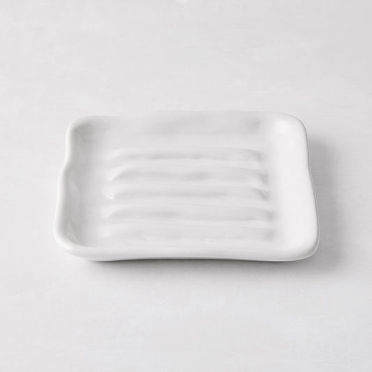 White handmade ceramic soap dish 5270 by Montes Doggett, 5" square with organic shape and multiple ridges.