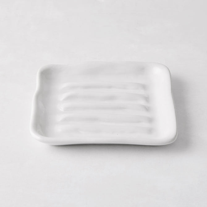 White handmade ceramic soap dish 5270 by Montes Doggett, 5" square with organic shape and multiple ridges.
