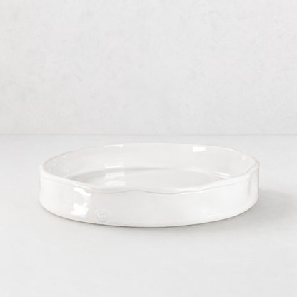 Handmade Montes Doggett ceramic tray, creamy white glaze, 11" round, wavy rim.