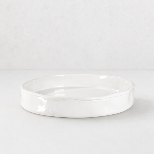 Handmade Montes Doggett ceramic tray, creamy white glaze, 11" round, wavy rim.